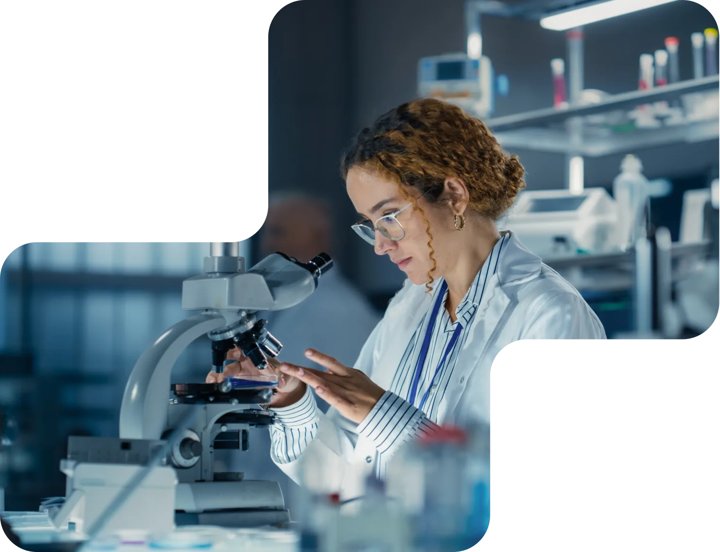 Scientist examining a sample under a microscope in the Steriscience laboratory